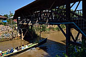 Inle Lake Myanmar. All the buildings are constructed on piles. Residents travel around by canoe, but there are also bamboo walkways and bridges over the canals, monasteries and stupas. 